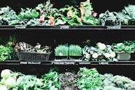 pexels photo 1216348 1216348 Vibrant display of fresh organic greens and vegetables in a market setting.